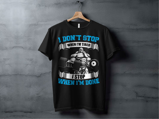 Black t-shirt with motivational graphic and text on a gray background
