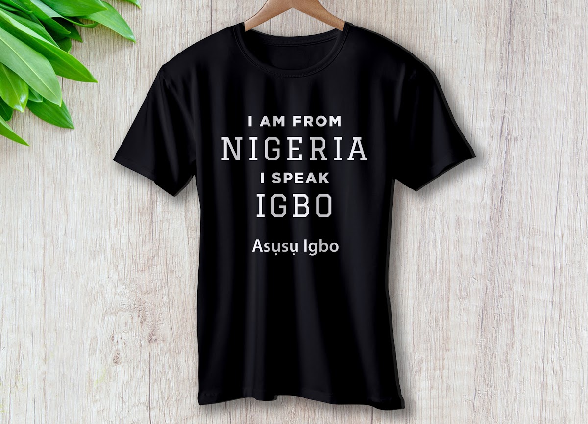 Person wearing Igbo heritage apparel featuring Igbo language text and cultural designs