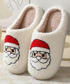 Cozy Christmas slippers with shearling texture resting by a fireplace with candles and chunky knits